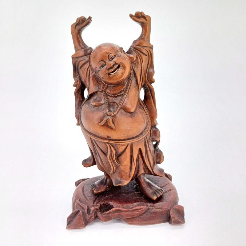 A carved rosewood figure of Putai, “The Happy Buddha,”