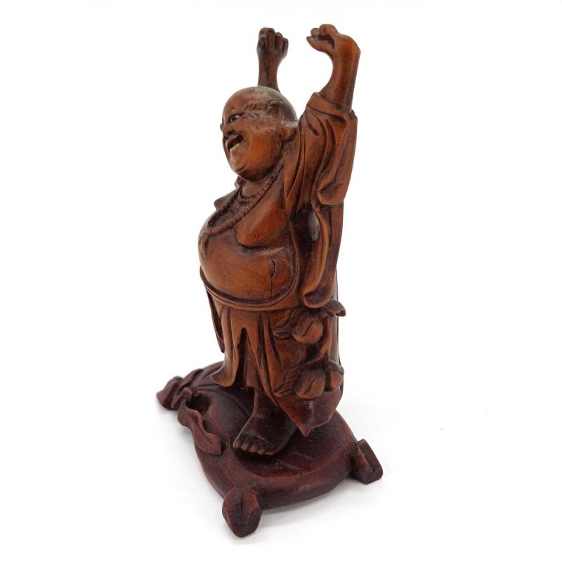 A carved rosewood figure of Putai, “The Happy Buddha,”